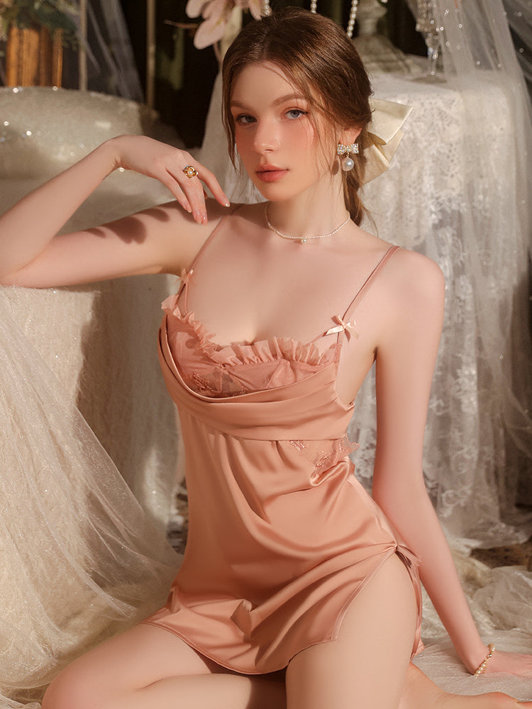 Elegant woman wearing a peach silk nightgown with delicate lace trim, posing gracefully in a luxurious setting.