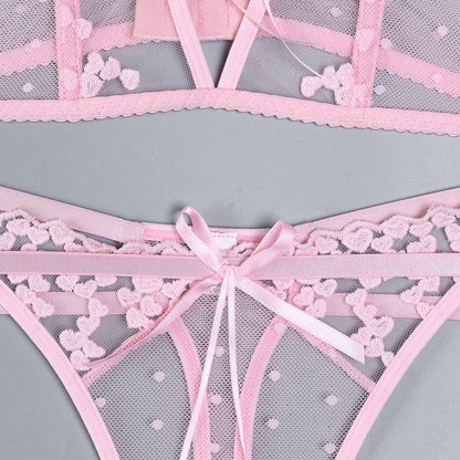 Floral accents on pink three-piece lingerie set