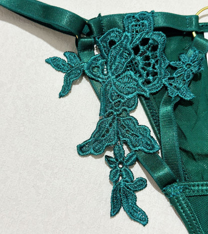 Green three-piece lingerie set featuring strappy