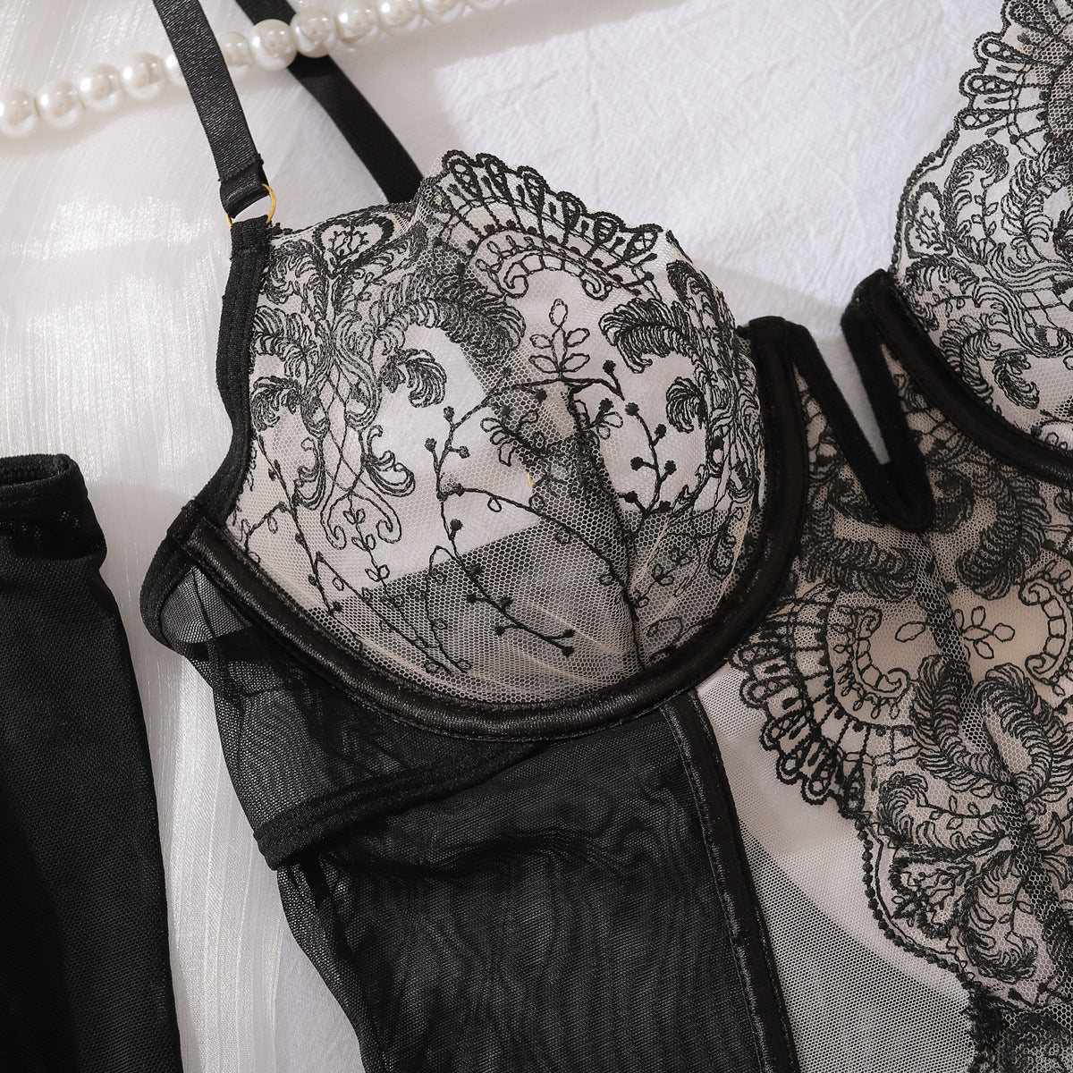 Black garter straps detailed three-piece lingerie set