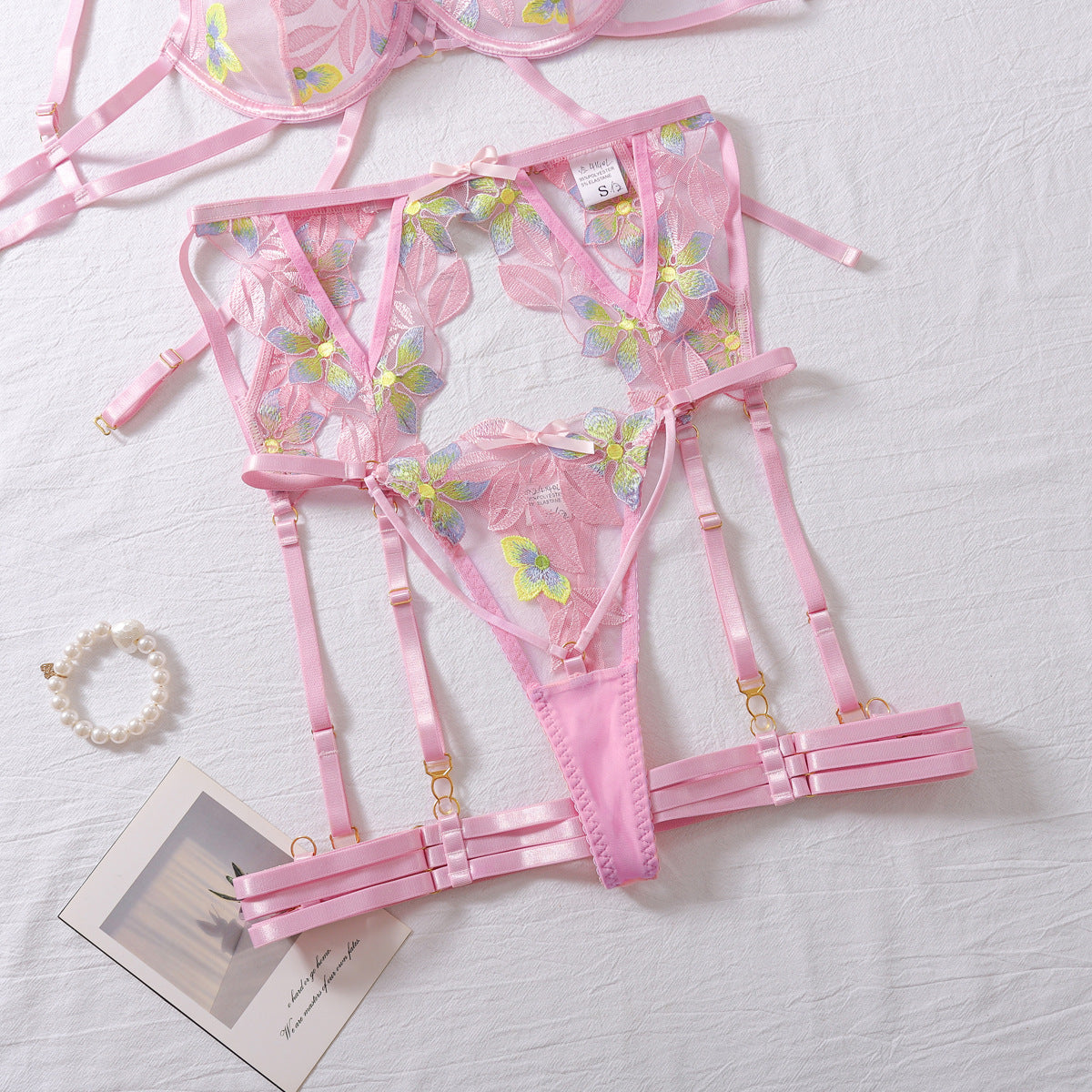 Pink four-piece lingerie set featuring embroidered