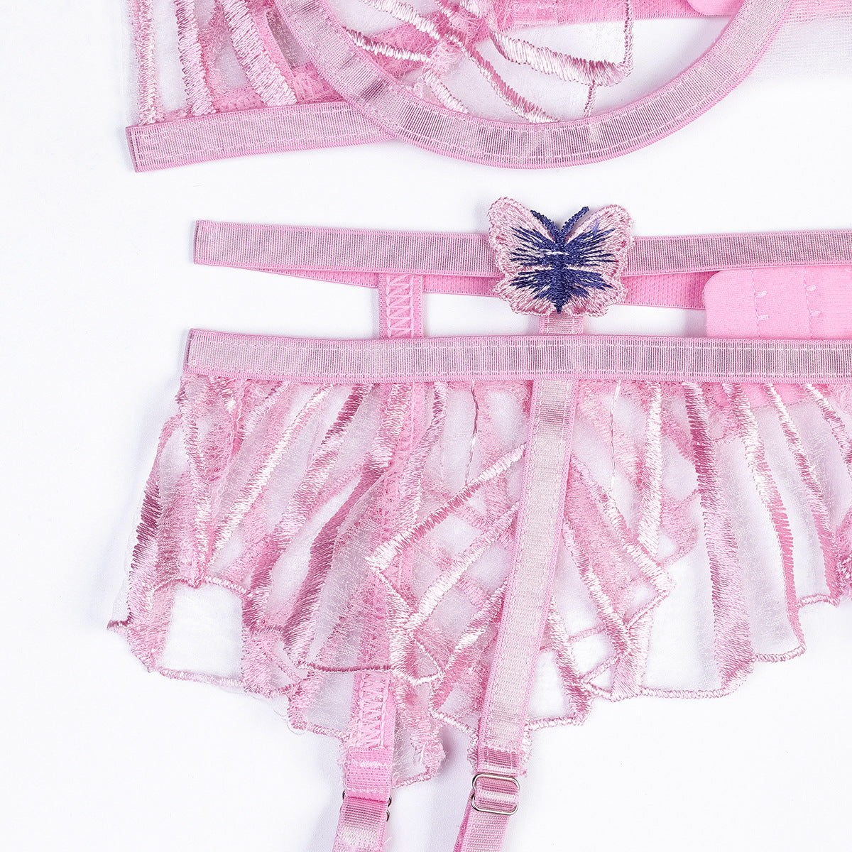 Cutout accents on pink three-piece lingerie set
