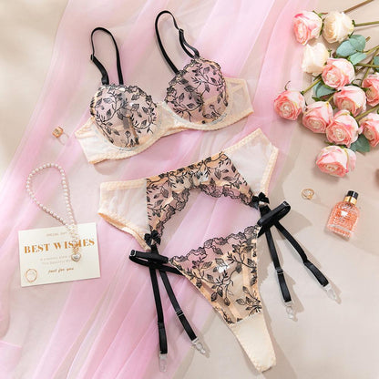 Black three-piece lingerie set with sheer mesh design