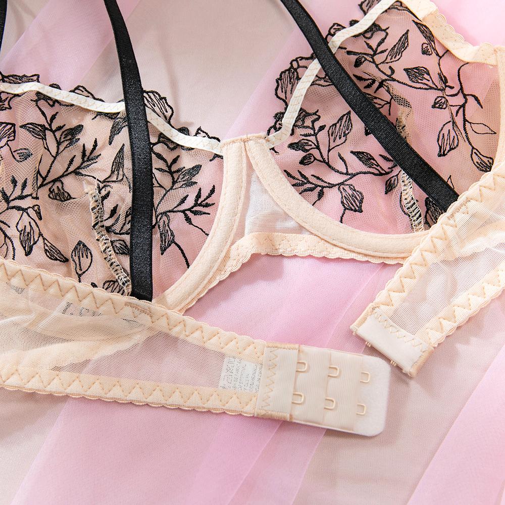 Black three-piece lingerie set featuring sheer mesh