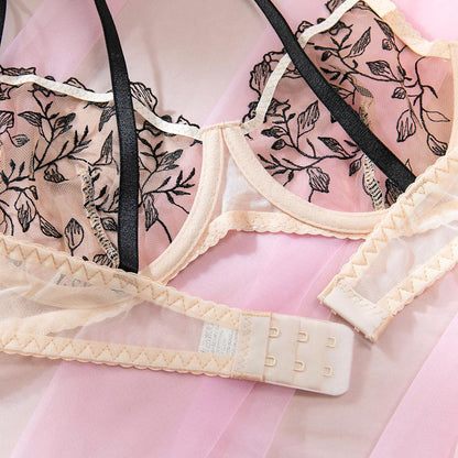 Black three-piece lingerie set featuring sheer mesh