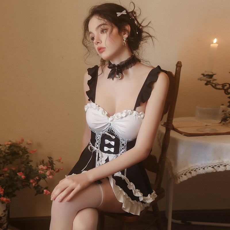 Seated portrait in black and white ruffle maid cosplay dress