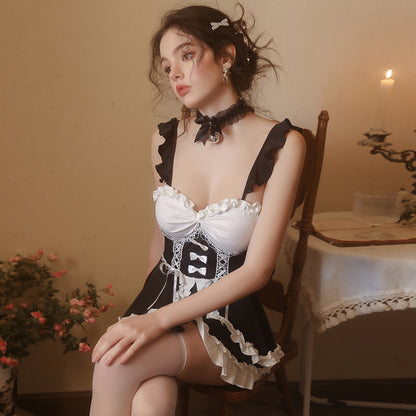 Seated portrait in black and white ruffle maid cosplay dress