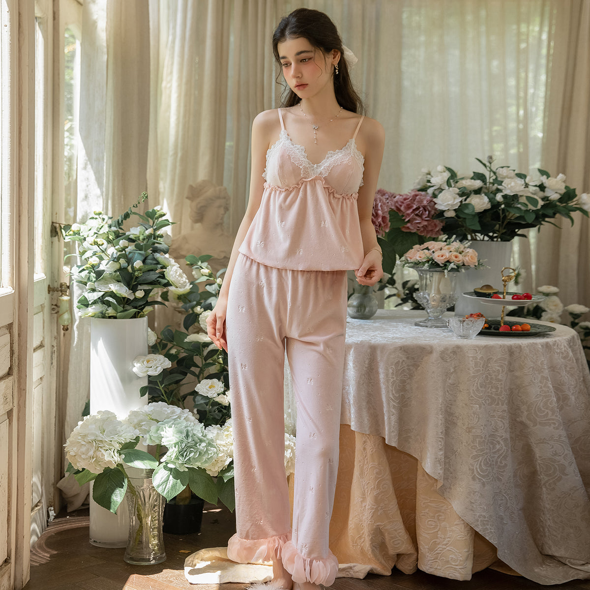 Standing model in the blush pink lace cami and matching long pajama pants