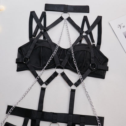 Harness accents on black four-piece lingerie set