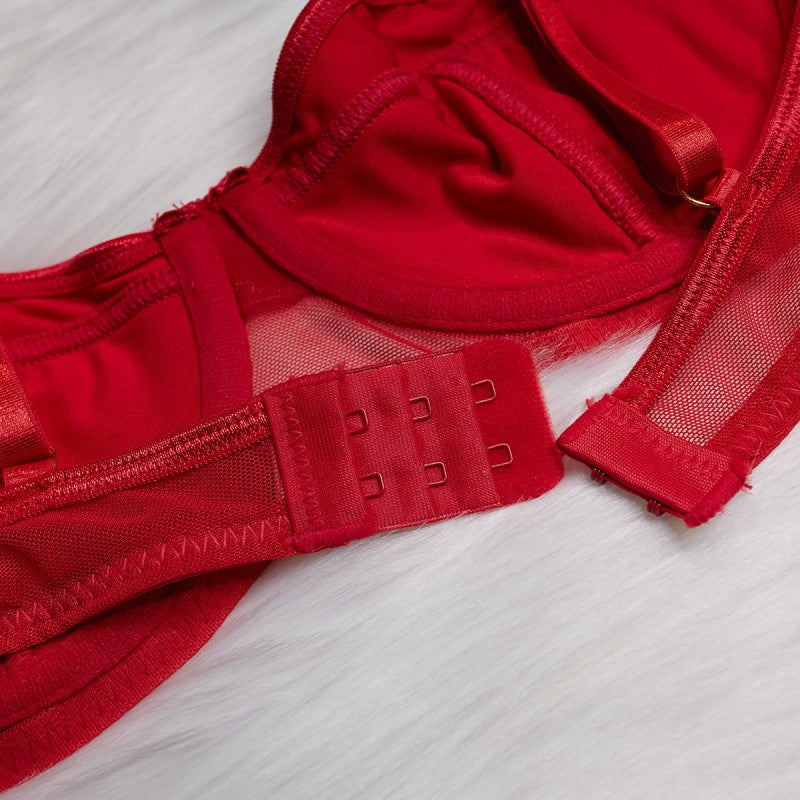 Strappy accents on red four-piece lingerie set