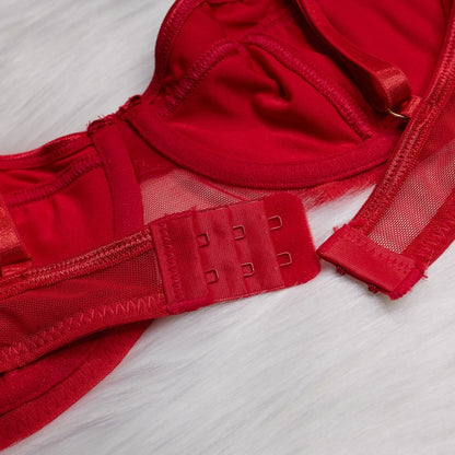 Strappy accents on red four-piece lingerie set