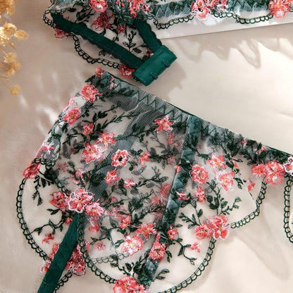 Green four-piece lingerie set featuring satin