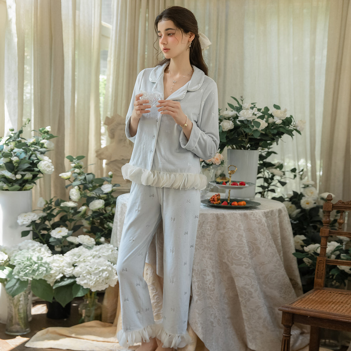 Full front view of the light blue button cardigan with matching long pajama pants