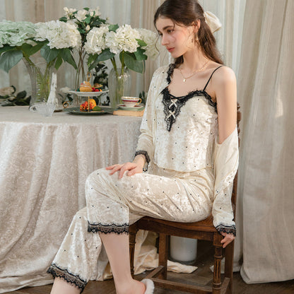 Seated model in the light yellow camisole and pants with the matching cardigan draped off the shoulders