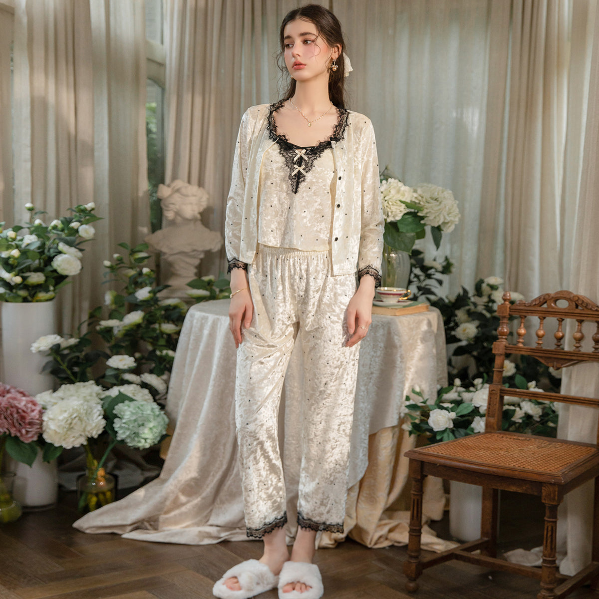 Model wearing the buttoned light yellow cardigan with matching lace-trim pajama pants