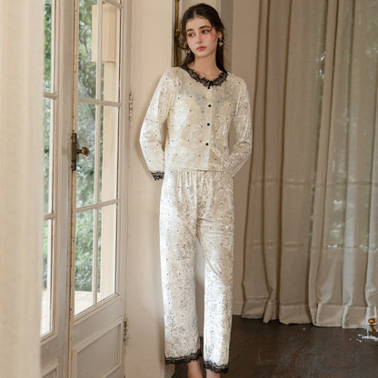 Full-length front view of the light yellow floral-textured pajama set with black lace trim